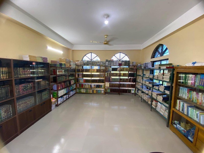 Madrasah library with shelves of Islamic texts and school books